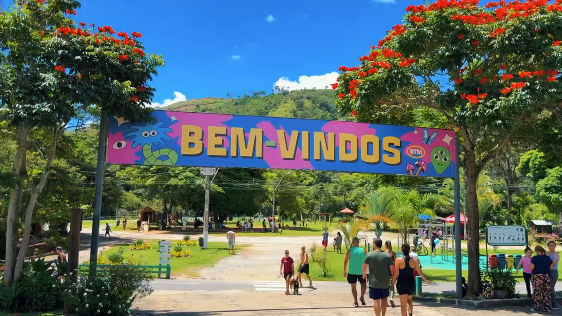 Famílias aproveitando Itaipava com crianças brincando e natureza ao redor.